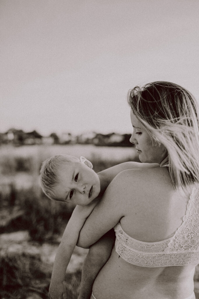 Family photography, mom holding son looking at the camera