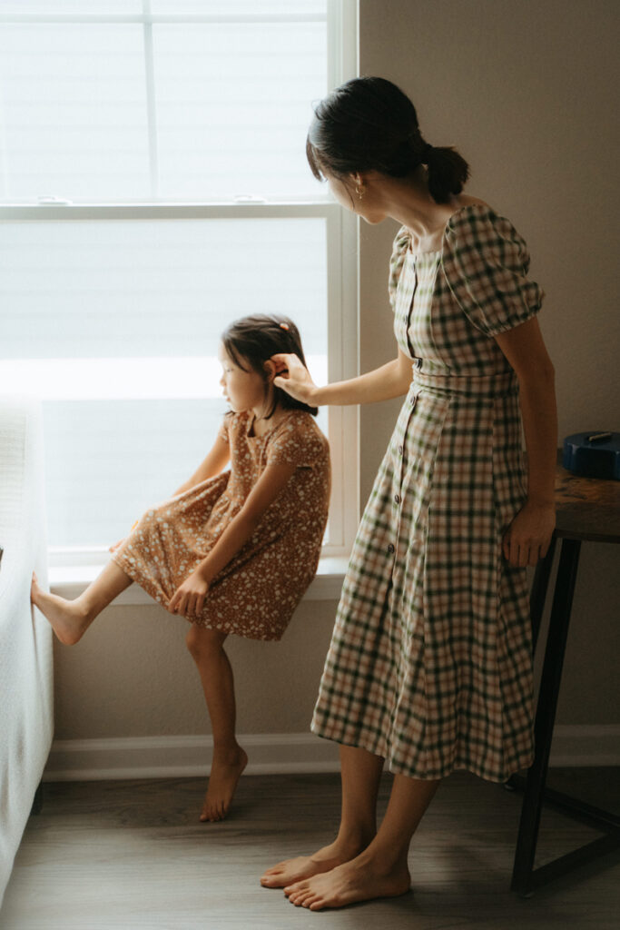 Family Photography, mother and daughter standing by the window